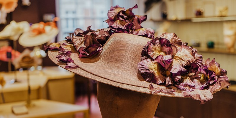 Above angle of pork pie hat and hands of young craftswoman